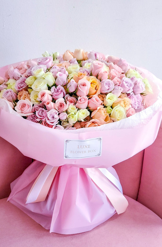 A delicate bouquet featuring spray roses in soft, pastel colors, arranged beautifully to create a charming and elegant display, perfect for expressing gentle affection or celebrating special moments.