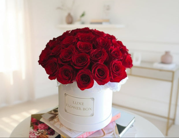 box of roses featuring a luxurious arrangement of vibrant red roses in a stylish flower box.
