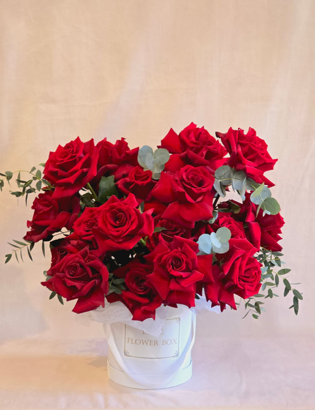 hand-fluffed roses with eucalyptus in a stylish flower box, perfect for elegant luxury gifting.
