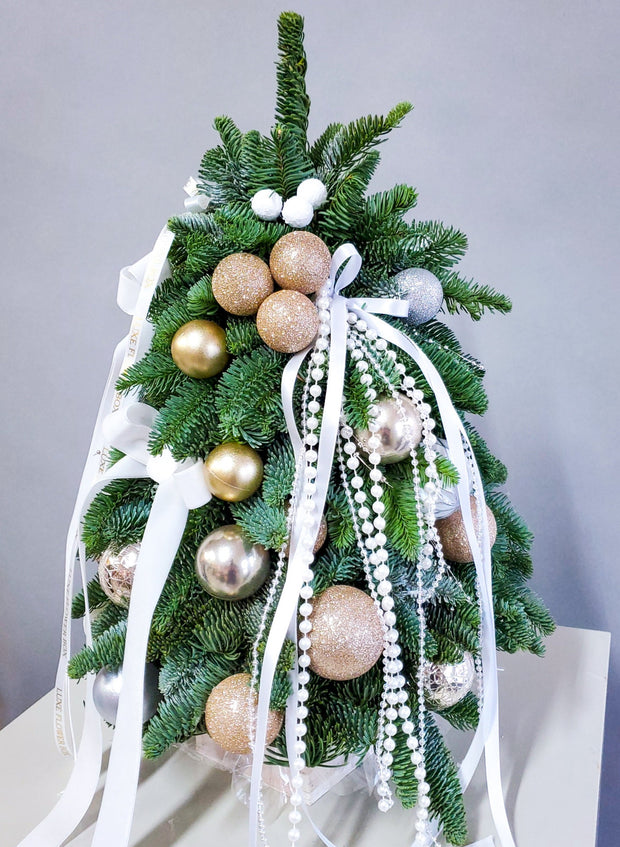 Mini Christmas tree decorated with ornaments and decor