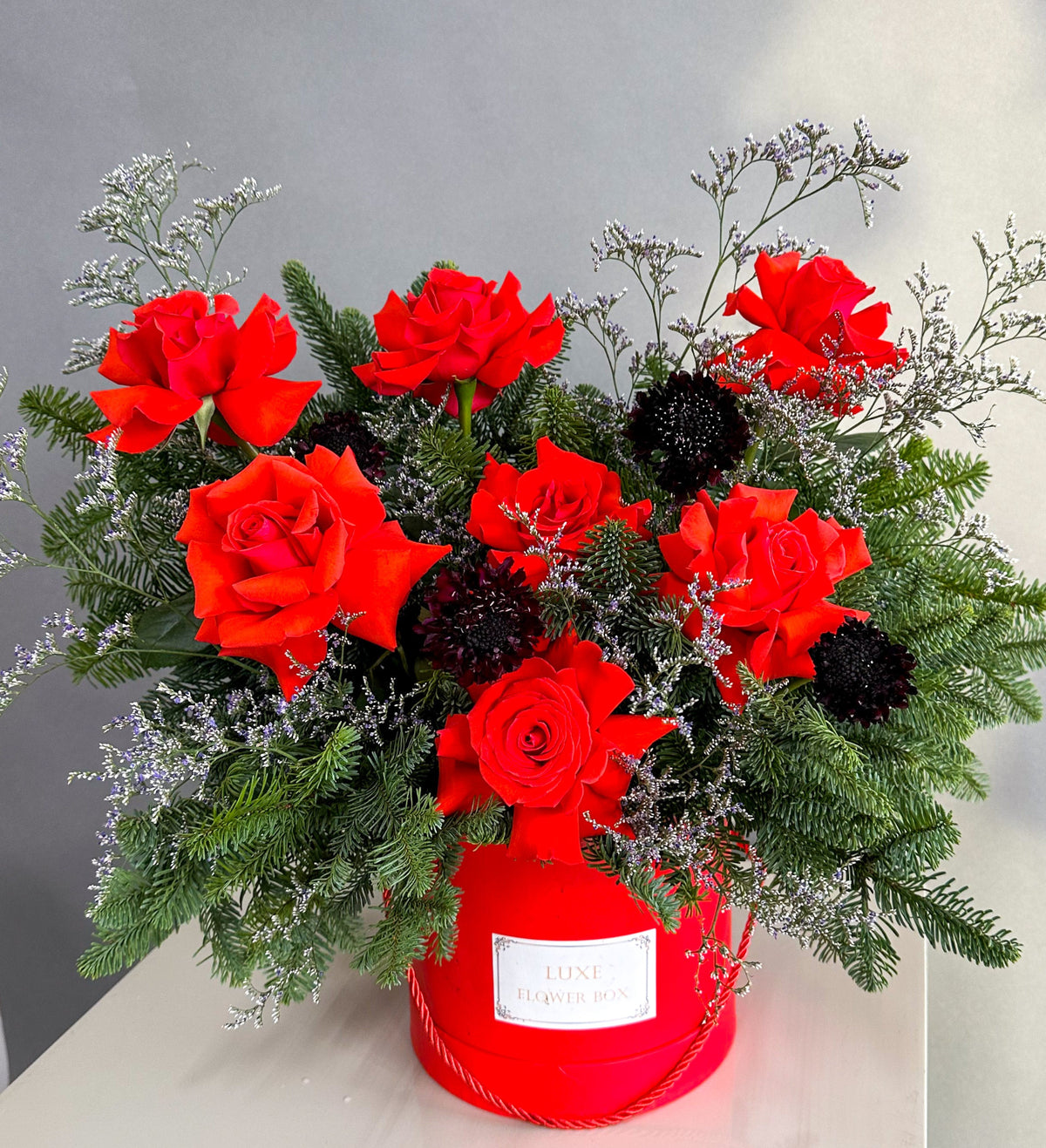 red roses with Christmas tree brunches